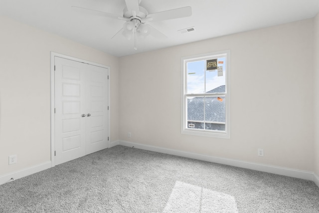 unfurnished bedroom featuring ceiling fan, carpet floors, and a closet