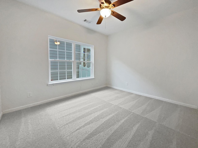 carpeted spare room featuring ceiling fan