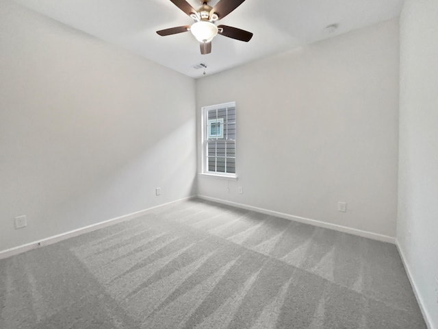 empty room featuring carpet floors and ceiling fan