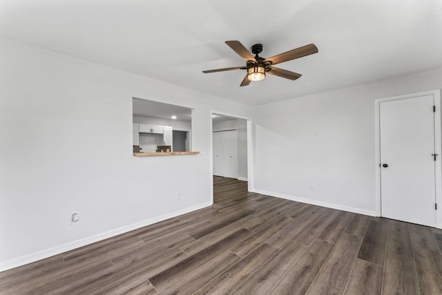 unfurnished living room featuring dark hardwood / wood-style flooring and ceiling fan