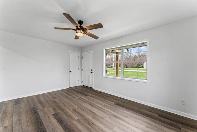 empty room featuring dark hardwood / wood-style floors and ceiling fan