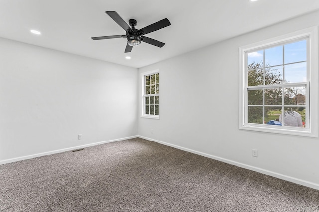 carpeted empty room featuring ceiling fan