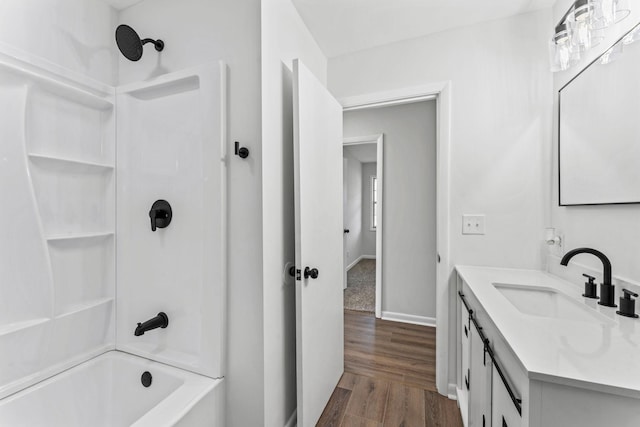 bathroom with hardwood / wood-style floors, vanity, and bathing tub / shower combination