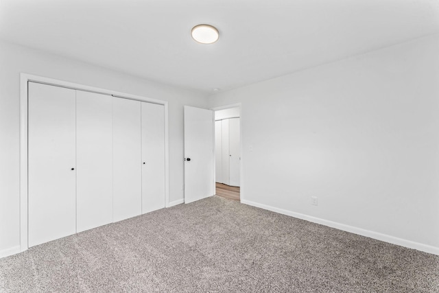 unfurnished bedroom with carpet and a closet