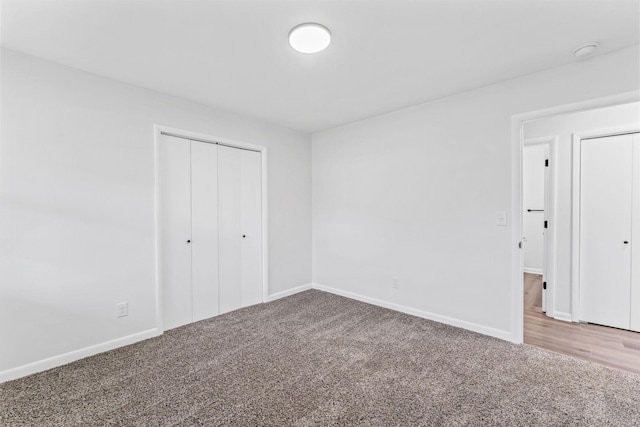 unfurnished bedroom featuring carpet flooring and a closet