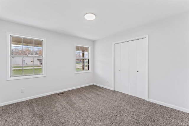 unfurnished bedroom with a closet and carpet floors