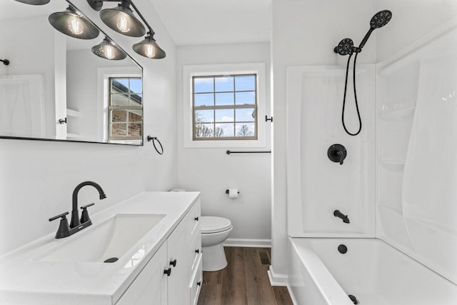 full bathroom with hardwood / wood-style floors, vanity, bathtub / shower combination, and toilet