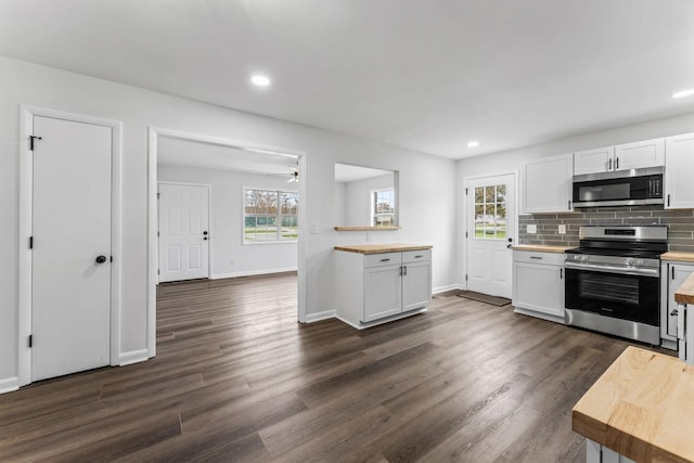 kitchen with white cabinetry, stainless steel appliances, and a wealth of natural light