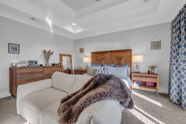 bedroom with carpet flooring, a tray ceiling, and crown molding