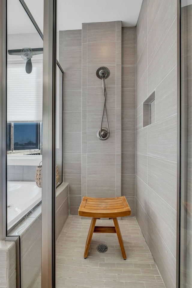 bathroom featuring separate shower and tub