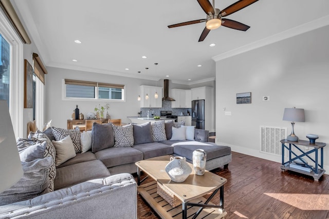 living room featuring crown molding, sink, ceiling fan, and dark hardwood / wood-style floors