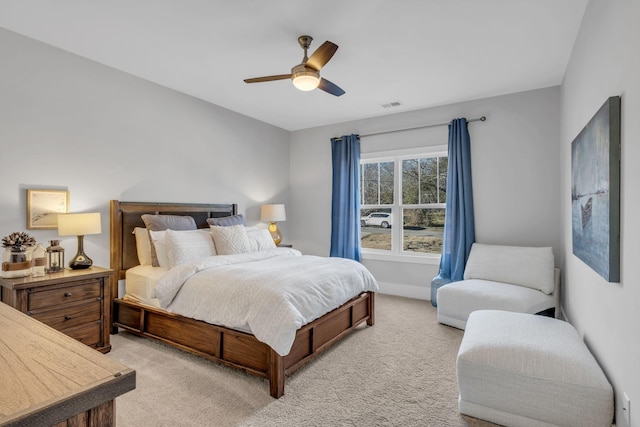 bedroom featuring light colored carpet and ceiling fan