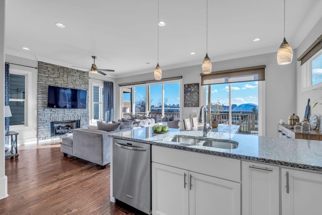 kitchen featuring dishwasher, white cabinets, and hanging light fixtures