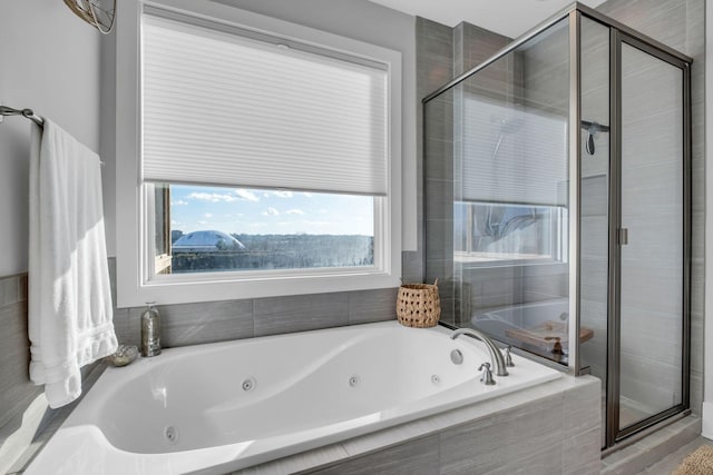 bathroom featuring separate shower and tub