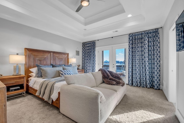 bedroom with light carpet, french doors, access to outside, a raised ceiling, and ceiling fan