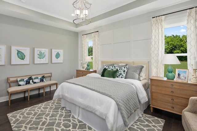 bedroom featuring a chandelier, ornamental molding, and dark wood-type flooring