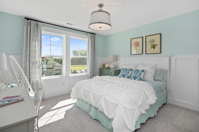 bedroom featuring light colored carpet