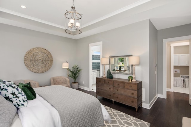 bedroom with dark hardwood / wood-style flooring, ornamental molding, and an inviting chandelier