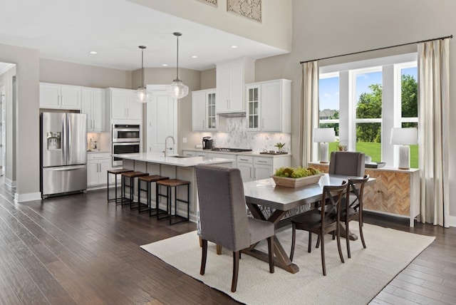 dining room with dark hardwood / wood-style flooring and sink