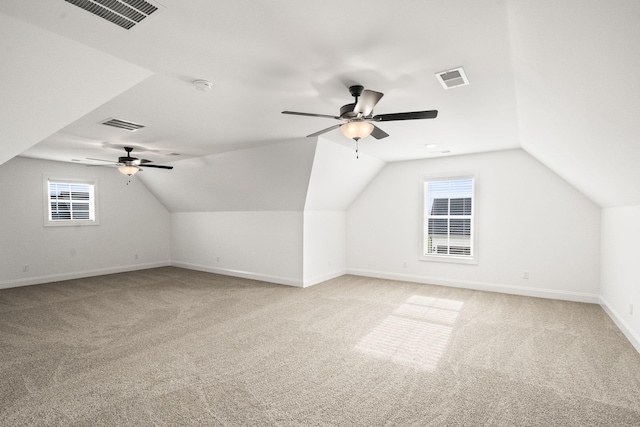 bonus room featuring ceiling fan, light carpet, and lofted ceiling