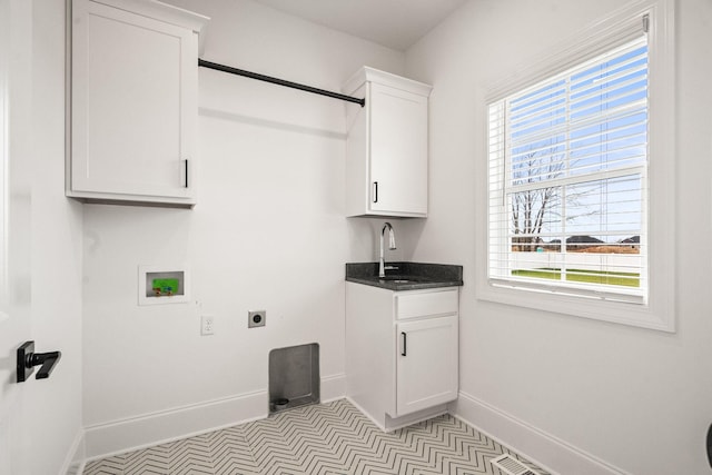 laundry room featuring cabinets, sink, hookup for a washing machine, light tile patterned floors, and hookup for an electric dryer