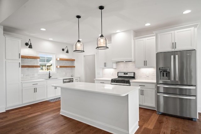 kitchen featuring premium range hood, sink, white cabinets, and appliances with stainless steel finishes