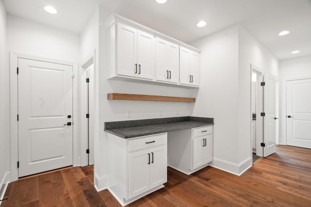 kitchen featuring white cabinetry and dark hardwood / wood-style floors