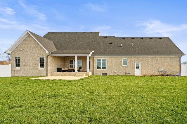 back of house featuring a lawn and a patio