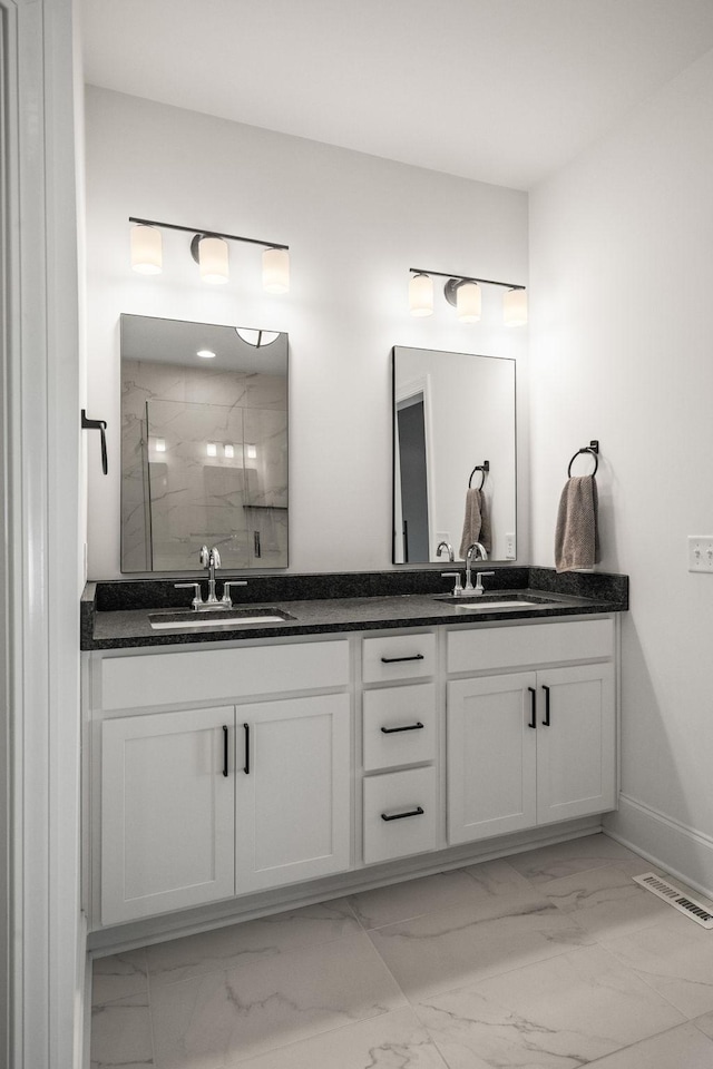 bathroom with vanity and a shower with door