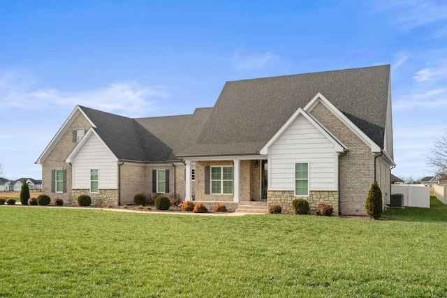 view of front of home featuring central AC unit and a front yard