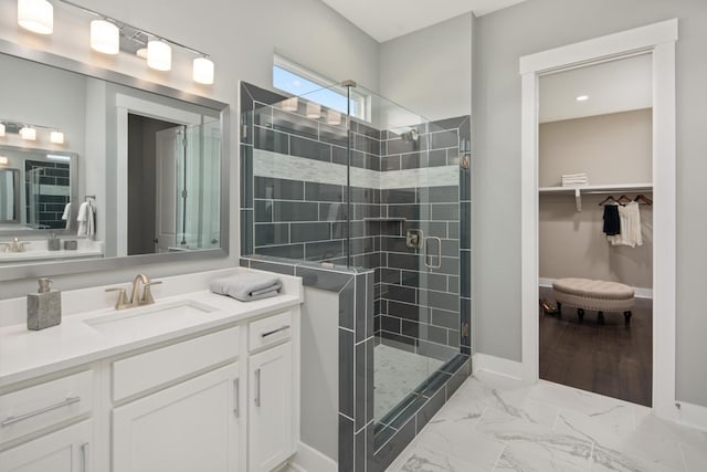 bathroom featuring vanity and a shower with door