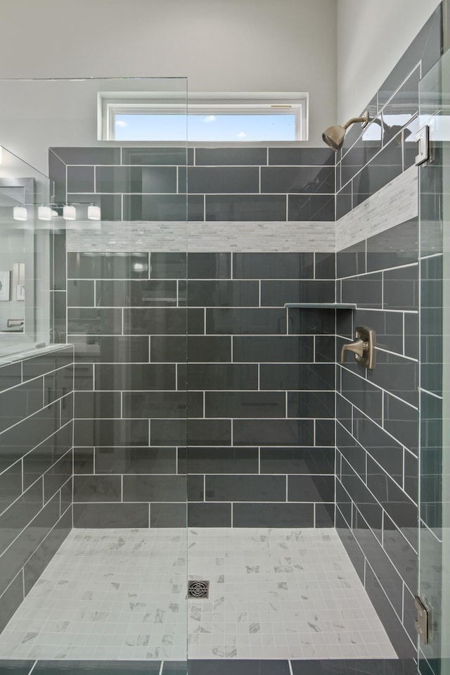 bathroom with a tile shower