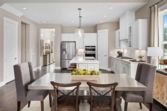 dining space featuring dark wood-type flooring