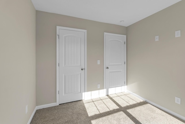 unfurnished bedroom featuring carpet and a closet