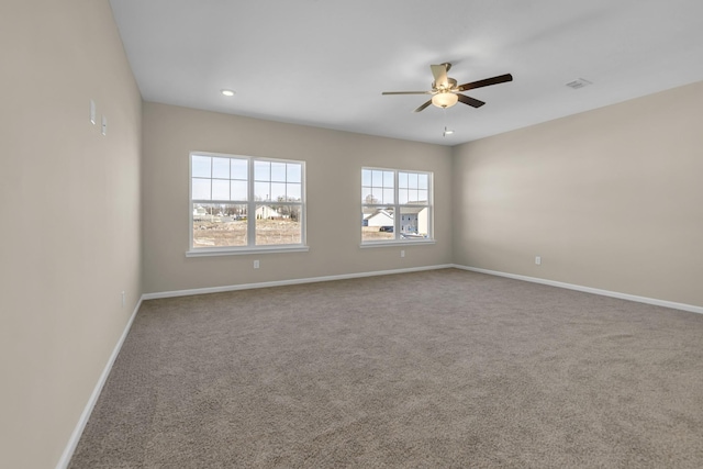 empty room featuring ceiling fan and carpet floors