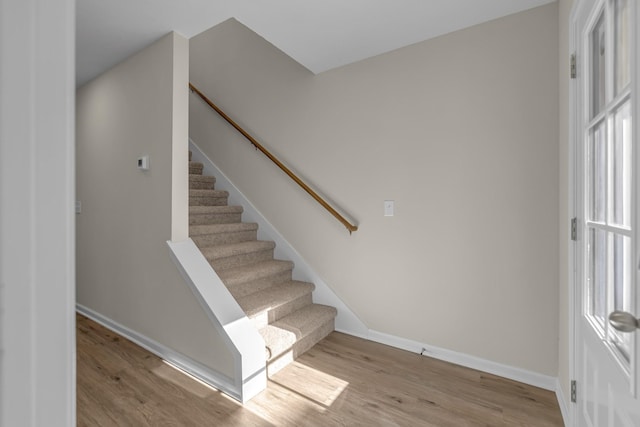 stairway with hardwood / wood-style floors