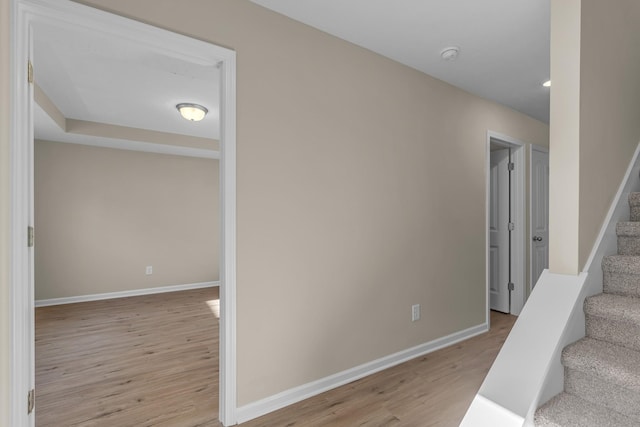 staircase with hardwood / wood-style flooring