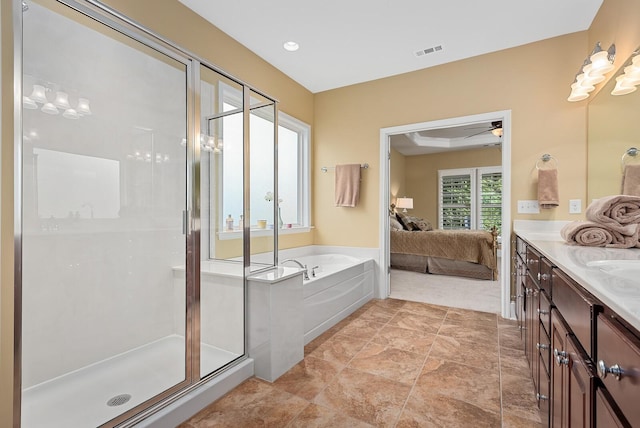 bathroom featuring ceiling fan, vanity, and plus walk in shower