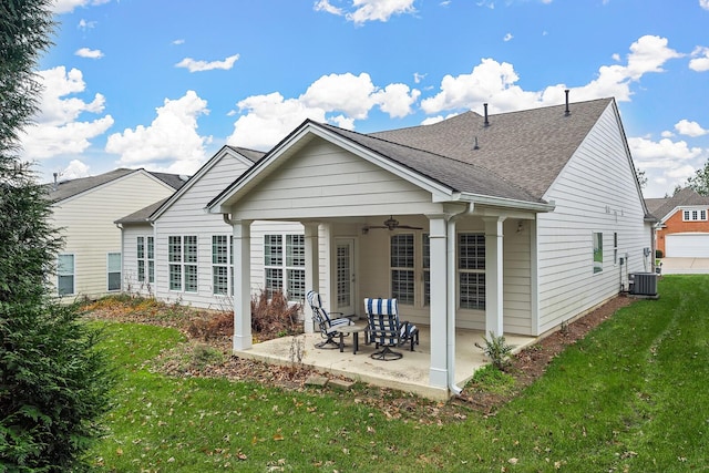 rear view of property featuring a lawn, central AC, ceiling fan, and a patio