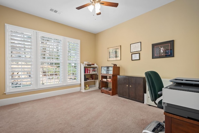 carpeted office space with ceiling fan