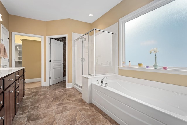 bathroom with vanity and independent shower and bath