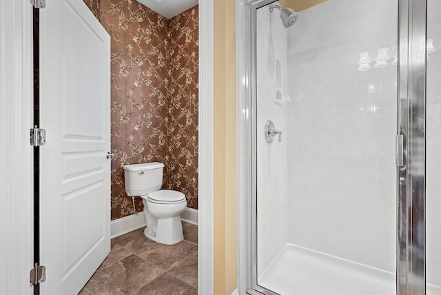 bathroom with toilet and a shower with shower door