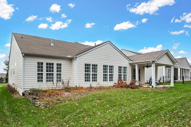 rear view of property featuring a yard, a patio, and ceiling fan