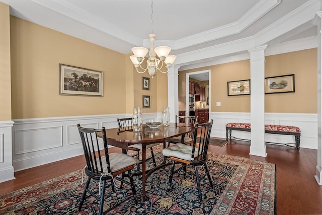 dining area featuring ornamental molding, dark wood-type flooring, and a notable chandelier