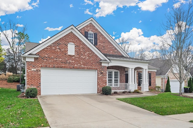 view of front of house featuring a front lawn, covered porch, and a garage