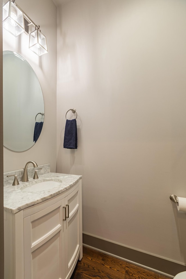 bathroom with hardwood / wood-style flooring and vanity