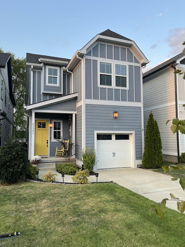 view of front of home featuring a garage and a front lawn