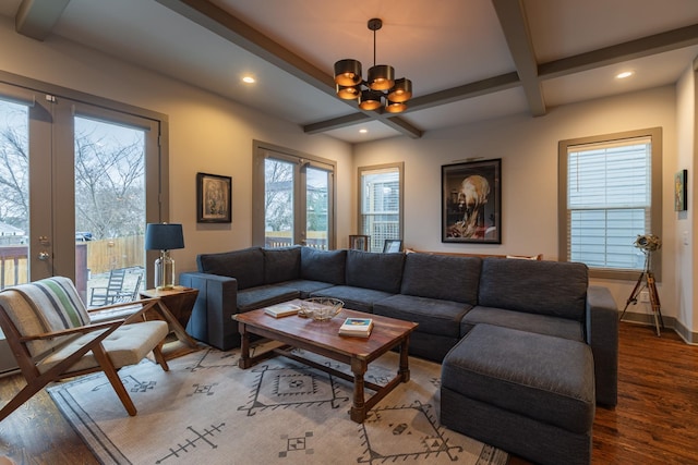 living room featuring plenty of natural light, french doors, hardwood / wood-style flooring, a notable chandelier, and beam ceiling