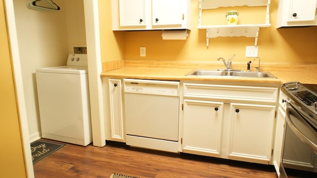 kitchen featuring white dishwasher, sink, stainless steel range oven, white cabinets, and washer / dryer