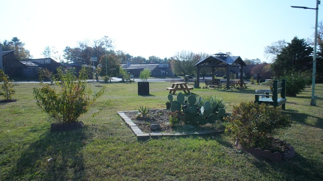 surrounding community with a gazebo and a yard